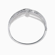 The Classique 14K White Gold Diamond Crossover Bangle features a twisted knot design with sparkling diamonds, shown against a plain white background.