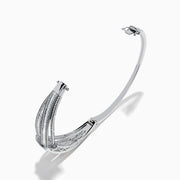 The Classique 14K White Gold Diamond Crossover Bangle features a twisted knot design with sparkling diamonds, shown against a plain white background.