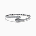 The Signature 14K White Gold White and Black Diamond Panther Bypass Bangle showcases two panther heads with sparkling diamond accents facing each other in an elegant, bypass-style design.