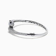 The Signature 14K White Gold White and Black Diamond Panther Bypass Bangle showcases two panther heads with sparkling diamond accents facing each other in an elegant, bypass-style design.