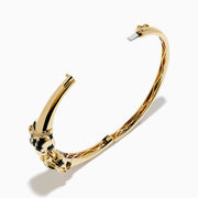 The Signature 14K Yellow Gold Diamond and Emerald Panther Bangle features two emerald-eyed panther heads facing each other, joined by a gold ring set with sparkling diamonds.