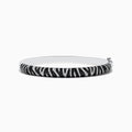 The 14k White Gold Black and White Diamond Zebra Print Bangle features a striking zebra stripe design with black and white diamond accents, elegantly set against plain white gold.