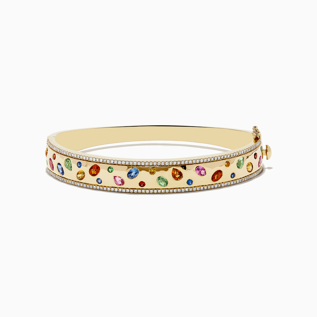 The Watercolor 14k Yellow Gold Bezel Set Multi Sapphire Bangle features vibrant sapphires set in 14k yellow gold, bordered with sparkling white diamonds for an elegant touch.