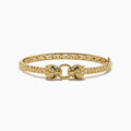 The Signature 14K Yellow Gold Emerald and Diamond Panther Bangle features two facing leopard heads with emerald-green eyes and pavé-set diamonds along the band, inspired by the iconic panther design.