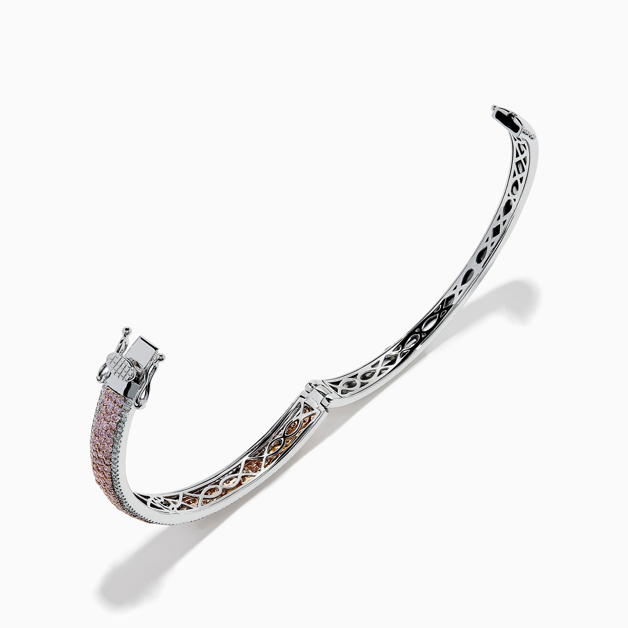 The 14K Two Tone Gold Pink and White Diamond Bangle features an intricate cutout design, accented by a central band with sparkling pink and white diamonds.
