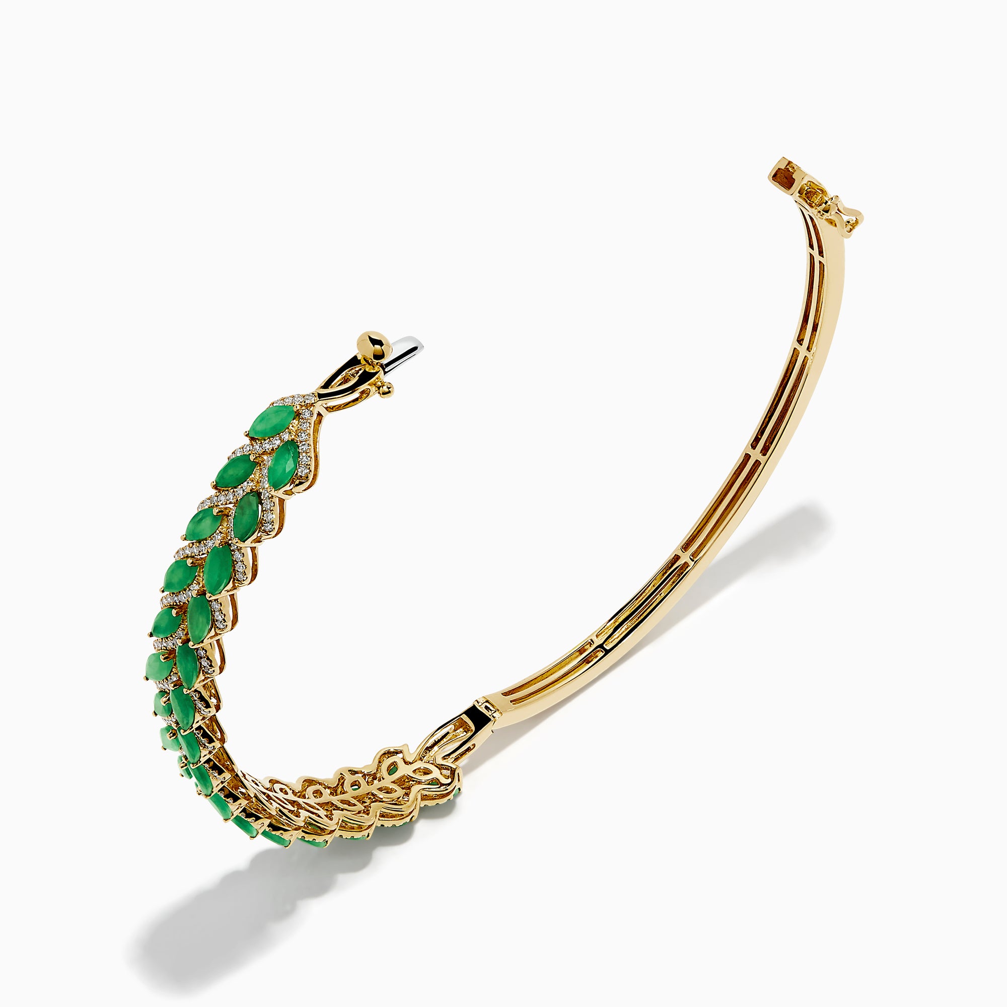 The 14K Yellow Gold Emerald and Diamond Marquise Leaf Bangle showcases an intricate leaf design with alternating emeralds and diamonds set along the band.
