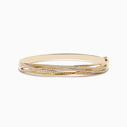 The 14K Yellow Gold Diamond Crossover Bracelet features multiple overlapping bands, some set with sparkling diamonds, for an elegant and intricate look.