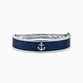 The Sterling Silver Pavé Blue Sapphire and Diamond Anchor Bangle features a small anchor design at the center, encrusted with blue sapphires and diamonds, shown against a plain white background.