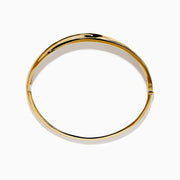 The 14K Yellow Gold Diamond Crossover Ribbon Bangle features overlapping bands in a crossover ribbon style, with some bands encrusted with sparkling diamonds for an elegant, layered look.