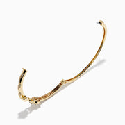 The Signature 14K Gold Diamond and Tsavorite Double Panther Head Bangle features two intertwined bands with geometric black and green enamel, diamond accents, and a panther motif, shown on a white background.