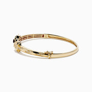 The Signature 14K Gold Diamond and Tsavorite Double Panther Head Bangle features two intertwined bands with geometric black and green enamel, diamond accents, and a panther motif, shown on a white background.