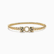 Introducing the Signature 14K Yellow Gold Diamond Chain-Link Panther Bangle Bracelet—a bold reinterpretation of the classic diamond bangle. This striking piece showcases an elegant chain-link design in 14K yellow gold, featuring two intricately sculpted panther heads adorned with green and clear gemstones, joined at the center by a sparkling, circular, gem-encrusted link.
