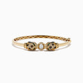 The Signature 14K Gold Emerald, White and Espresso Diamond Double Panther Head Bangle features two panther heads with emerald eyes, set with white and espresso diamonds, facing each other in a striking design.