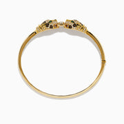 The Signature 14K Gold Emerald, White and Espresso Diamond Double Panther Head Bangle features two panther heads with emerald eyes, set with white and espresso diamonds, facing each other in a striking design.