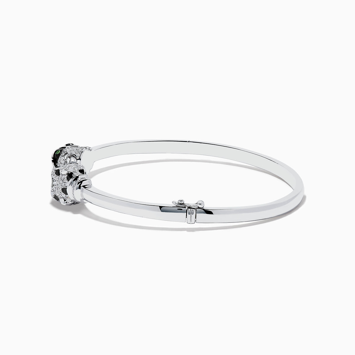 The Signature 14K White Gold Diamond and Tsavorite Bangle showcases two intricate panther heads facing each other, adorned with sparkling diamonds and vibrant tsavorite eyes.