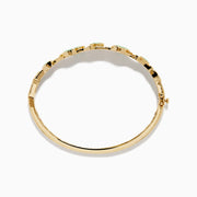 The 14K Yellow Gold Emerald and Diamond Bangle features oval green gemstones, sparkling white diamonds, an elegant openwork design, and a secure clasp.