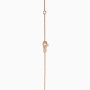 The Pave Rose 14K Rose Gold Diamond Circle Necklace showcases a circular pendant with two concentric rows of sparkling diamonds, shown on a white background.