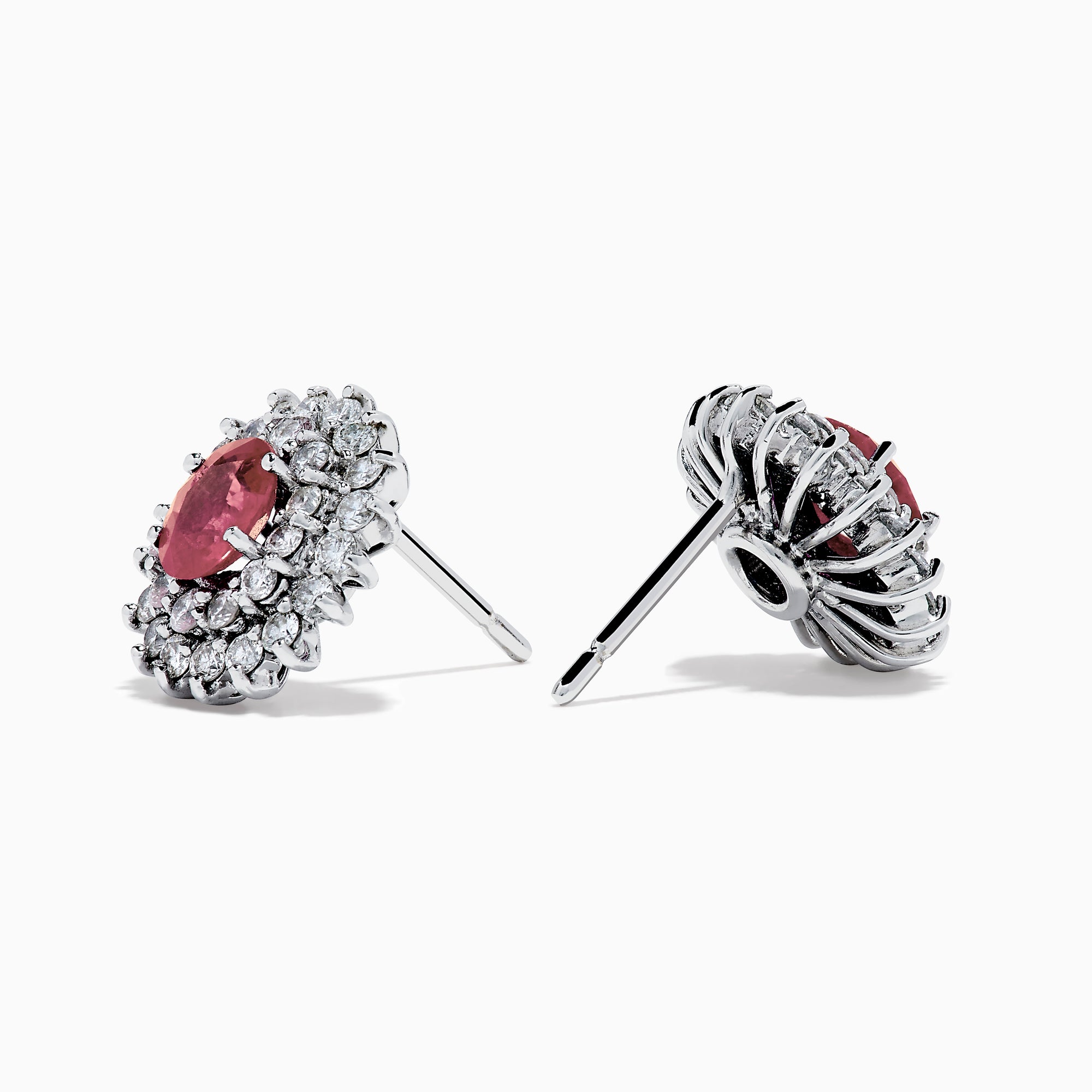 The Ruby Royale 18K White Gold Ruby and Diamond Earrings feature oval red rubies encircled by two halos of sparkling white diamonds, all set in elegant 18K white gold.