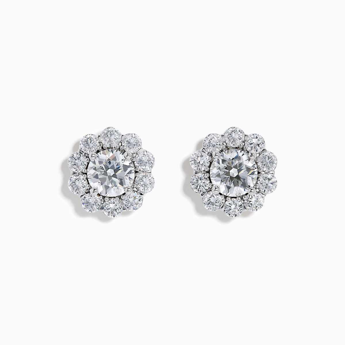 The Star Lab Grown Diamond Fleur Stud Earrings feature a central round diamond with a floral halo of smaller diamonds, beautifully set in 18K white gold for a timeless look.