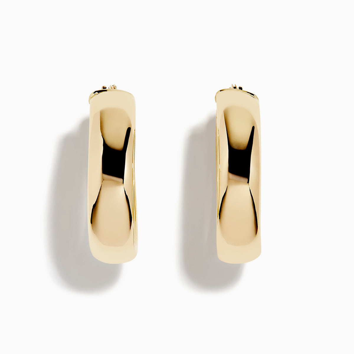 A pair of 14K Yellow Gold Hoops with a smooth, rounded surface shines brightly, displayed vertically against a plain white background.