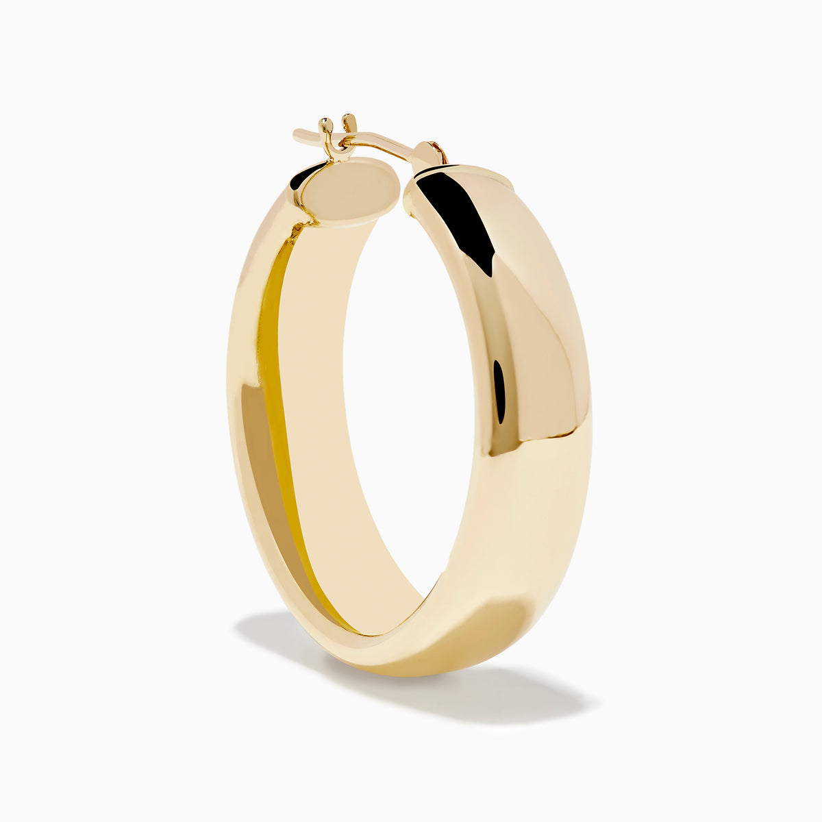 A pair of 14K Yellow Gold Hoops with a smooth, rounded surface shines brightly, displayed vertically against a plain white background.