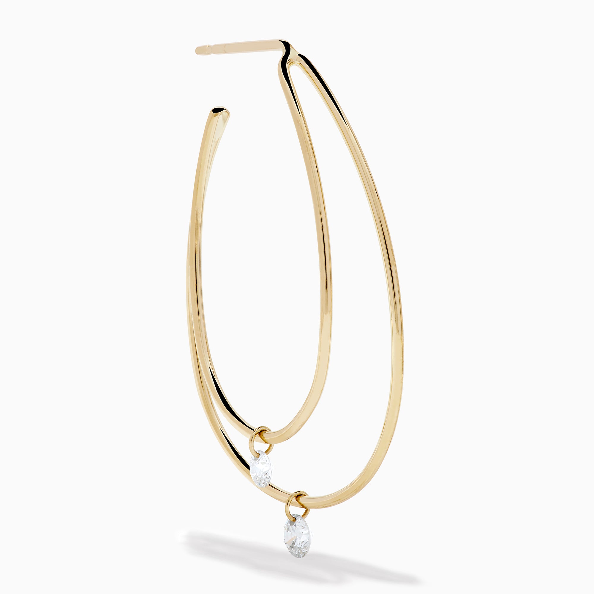 The 14K Yellow Gold Floating Diamond Double Hoop Earrings feature two elongated hoops in yellow gold, each accented with a small floating diamond, and are displayed against a plain white background.