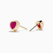 14K Yellow Gold Ruby Heart Earrings feature heart-shaped deep pink rubies set in the center, displayed on a white background—stylish and perfect for any occasion.