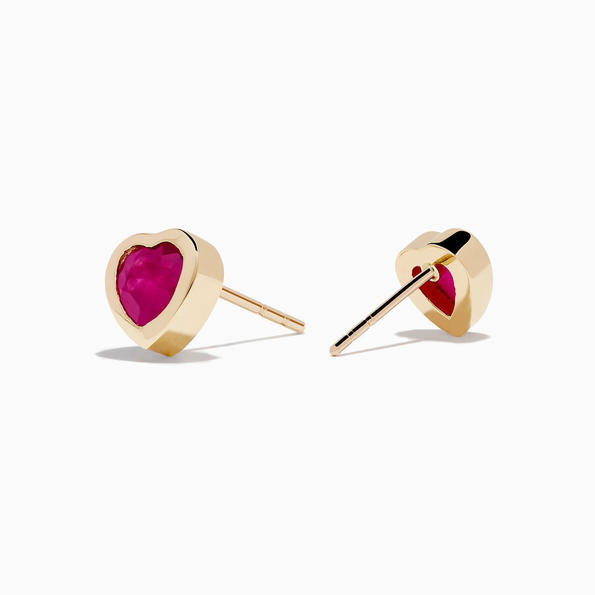 14K Yellow Gold Ruby Heart Earrings feature heart-shaped deep pink rubies set in the center, displayed on a white background—stylish and perfect for any occasion.