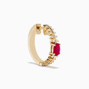 The 14K Yellow Gold Ruby and Diamond Hoops feature a central oval ruby accented by sparkling round diamonds on both sides—a stunning addition to your jewelry collection.