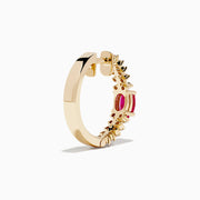 The 14K Yellow Gold Ruby and Diamond Hoops feature a central oval ruby accented by sparkling round diamonds on both sides—a stunning addition to your jewelry collection.