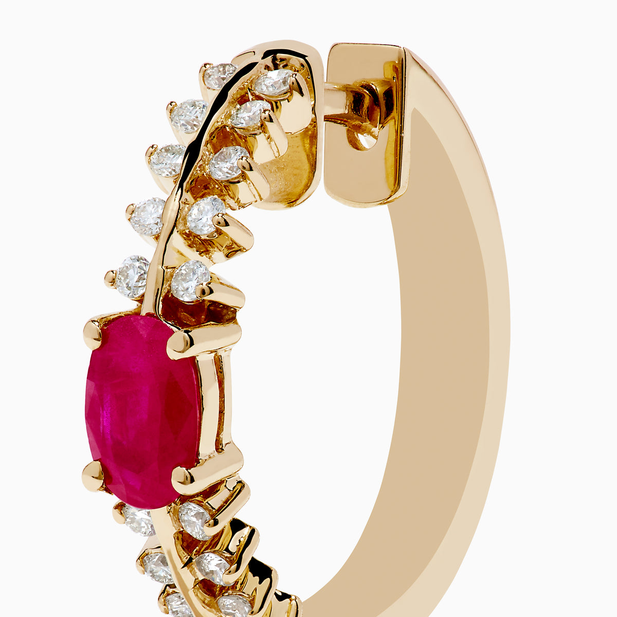 The 14K Yellow Gold Ruby and Diamond Hoops feature a central oval ruby accented by sparkling round diamonds on both sides—a stunning addition to your jewelry collection.