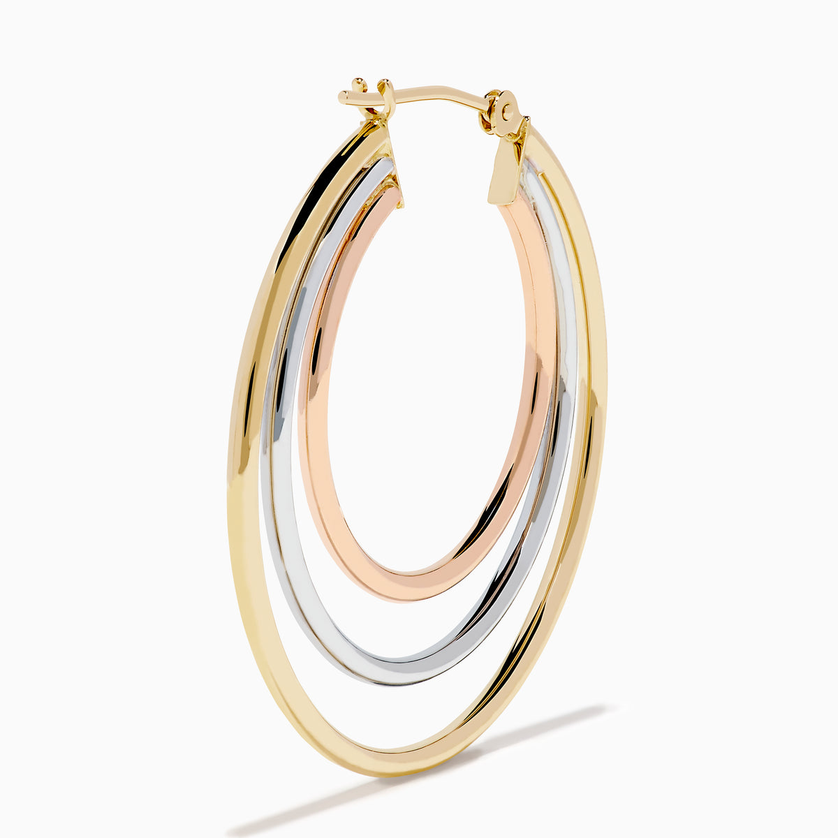 The 14K Three Tone Gold Triple Tube Hoop Earrings are displayed against a white background, with one earring shown front-facing and the other in a side view to highlight the intertwined gold, silver, and rose gold bands.