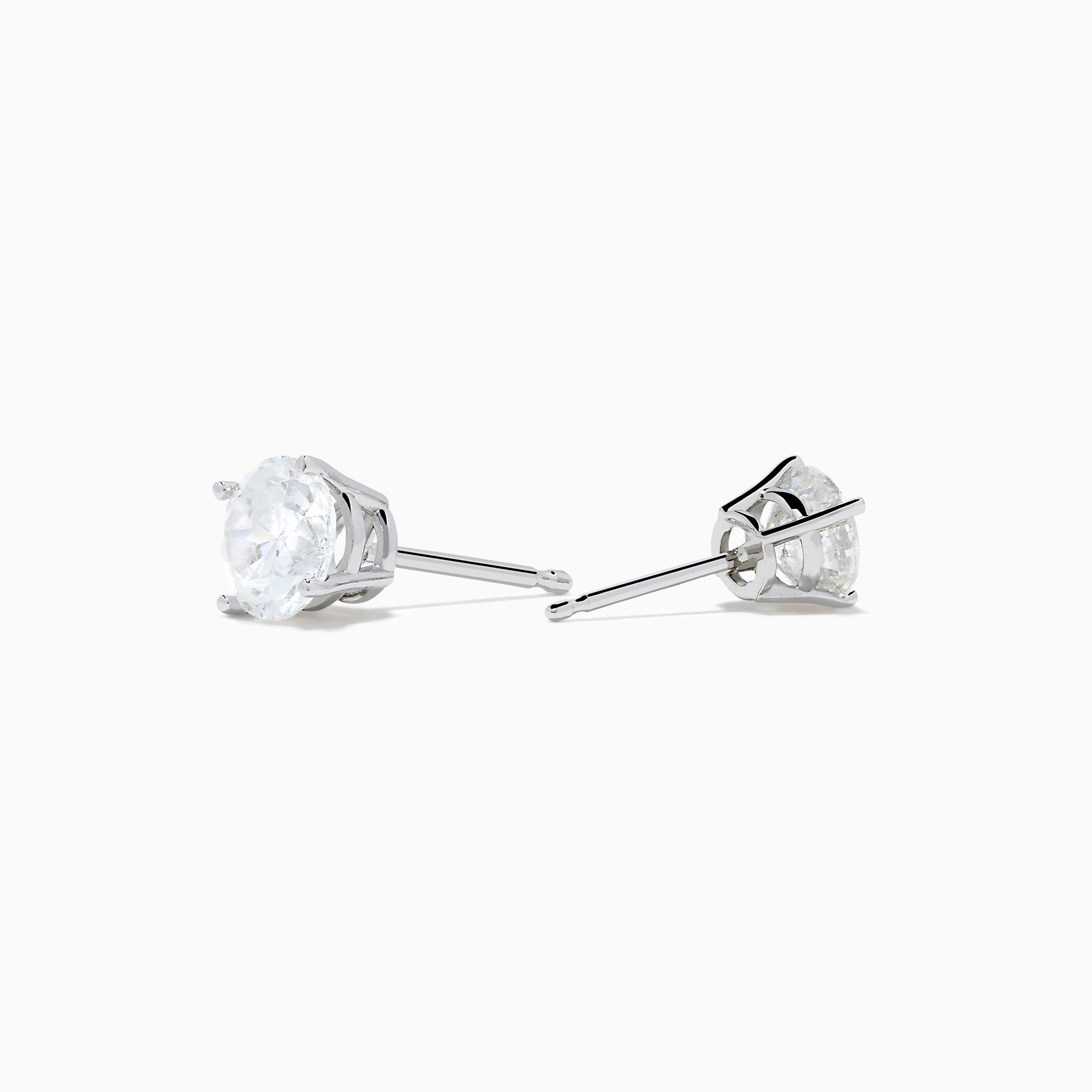 The 14K White Gold 1.18ct Brilliant Round Diamond Solitaire Stud Earrings feature sparkling diamonds in classic prong settings, showcased on a simple white background.