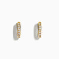 The 14K Yellow Gold Channel Set Diamond Mini Hoop Earrings feature a row of sparkling round diamonds, elegantly displayed on a white background.