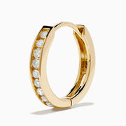 The 14K Yellow Gold Channel Set Diamond Mini Hoop Earrings feature a row of sparkling round diamonds, elegantly displayed on a white background.