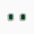The 14K Two Tone Gold Emerald and Diamond Earrings feature rectangular emerald green studs bordered by round white stones, set in 14K gold. These earrings are shown on a plain white background.