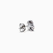 The 14K White Gold Yellow Diamond Love Knot Earrings feature an intricate love knot design with polished and textured finishes, crafted in 14K white gold, and are shown on a plain white background.