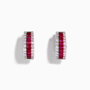 The 14K White Gold Ruby and Diamond Huggie Earrings feature a central row of square-cut red rubies, flanked by rows of round diamonds for extra brilliance.