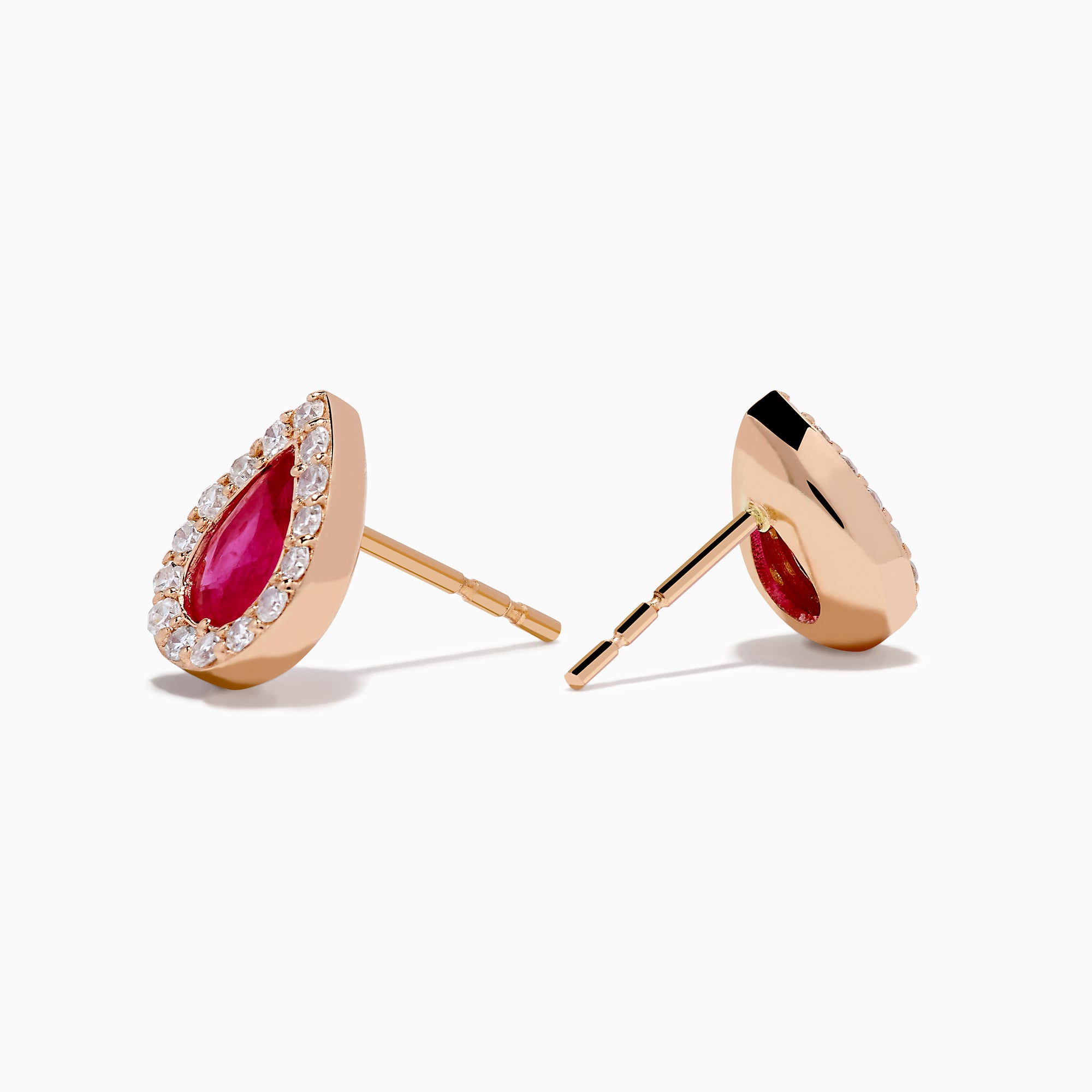 A pair of 14K rose gold ruby and diamond pear halo stud earrings with red rubies framed by diamonds, shown on a white background.