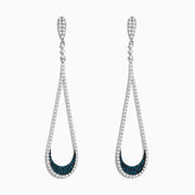 The 14K White Gold Blue and White Diamond Drop Earrings feature teardrop loops accented with sparkling white stones and blue stones near the bottom for a timeless, elegant look.