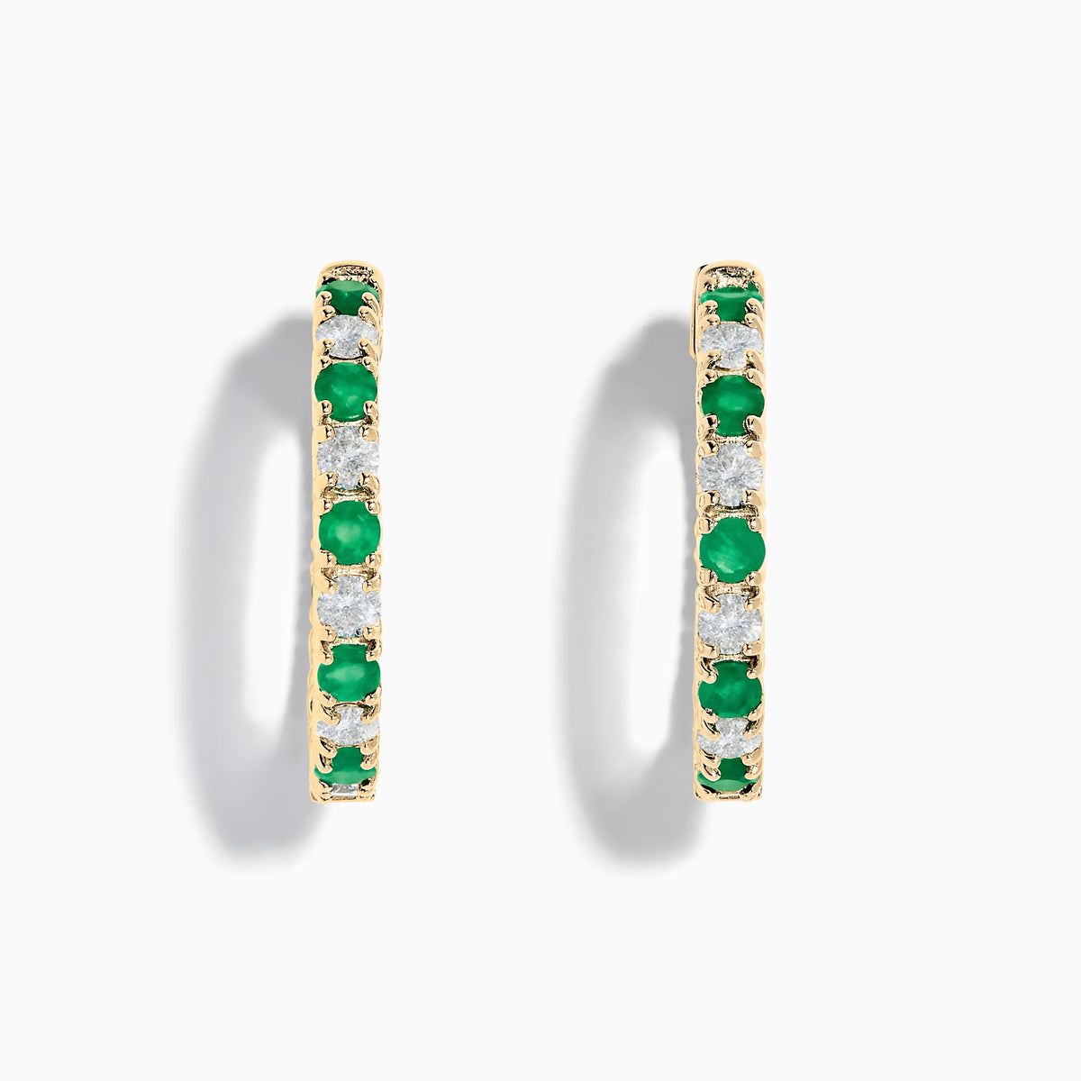 Displayed against a white background, these 14K yellow gold hoop earrings feature alternating emerald and diamond gemstones (3.58 TCW), making for a striking and elegant pair.