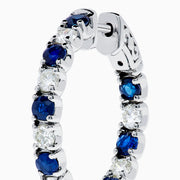 A pair of 14K White Gold Blue Sapphire & Diamond Hoop Earrings, 3.58 TCW, showcased against a plain white background.