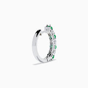 A pair of 14K white gold emerald & diamond hoop earrings, 1.10 TCW, featuring alternating green and clear gemstones set in a silver band, displayed on a white background with soft shadows.