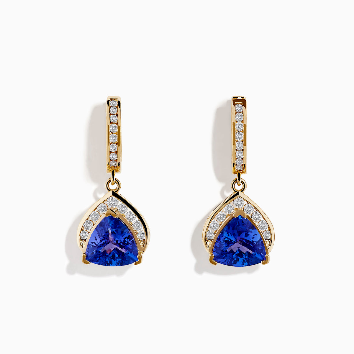 The Nahla Siri 14K Yellow Gold Trillion Tanzanite and Diamond Earrings feature triangular blue tanzanites framed by diamonds, with extra diamonds accenting the vertical gold bars above.
