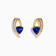 14K Yellow Gold Tanzanite and Diamond Drop Earrings featuring triangular blue tanzanite stones and a curved row of sparkling diamonds per earring, shown against a plain white background.