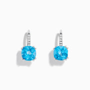 A pair of 14K White Gold Blue Topaz and Diamond Drop Earrings, featuring cushion-cut blue topaz and a row of diamonds on the hooks, displayed on a white background.