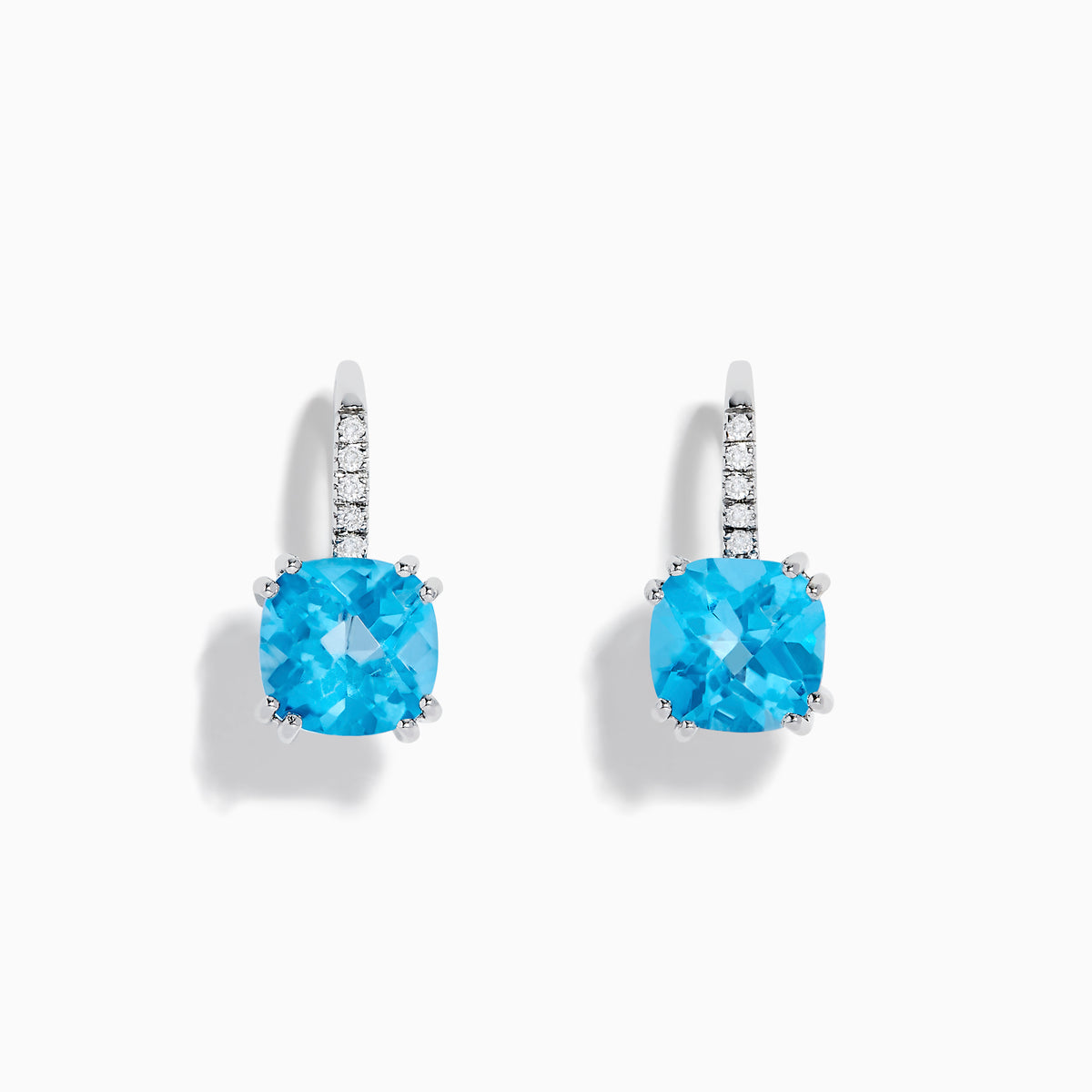 A pair of 14K White Gold Blue Topaz and Diamond Drop Earrings, featuring cushion-cut blue topaz and a row of diamonds on the hooks, displayed on a white background.
