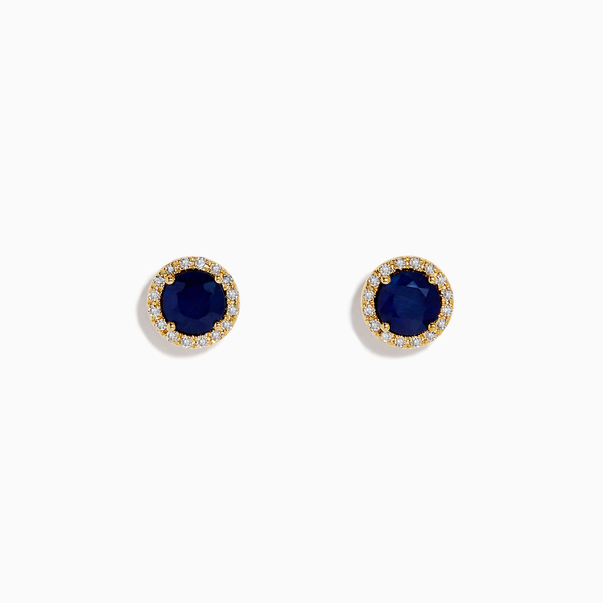 The 14K Yellow Gold Sapphire and Diamond Halo Stud Earrings feature deep blue sapphires at the center, each encircled by sparkling diamonds and displayed on a white background.
