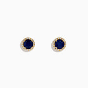 The 14K Yellow Gold Sapphire and Diamond Halo Stud Earrings feature deep blue sapphires at the center, each encircled by sparkling diamonds and displayed on a white background.