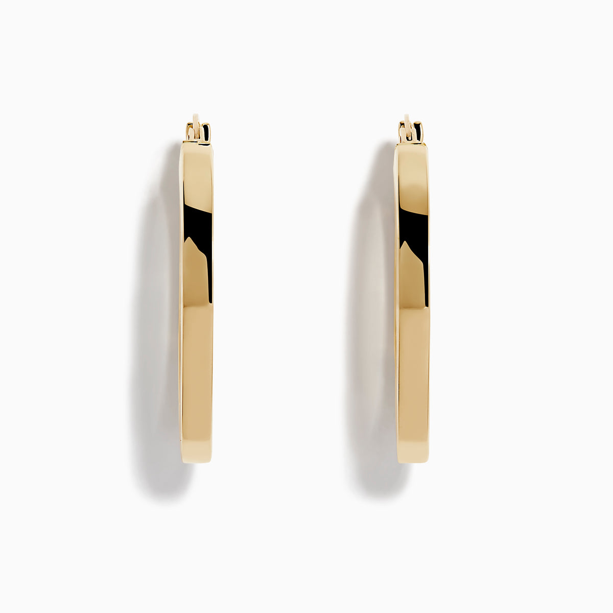 A pair of 14K Yellow Gold Square Tube Oval Hoop Earrings displayed vertically on a white background, casting soft shadows to the right.